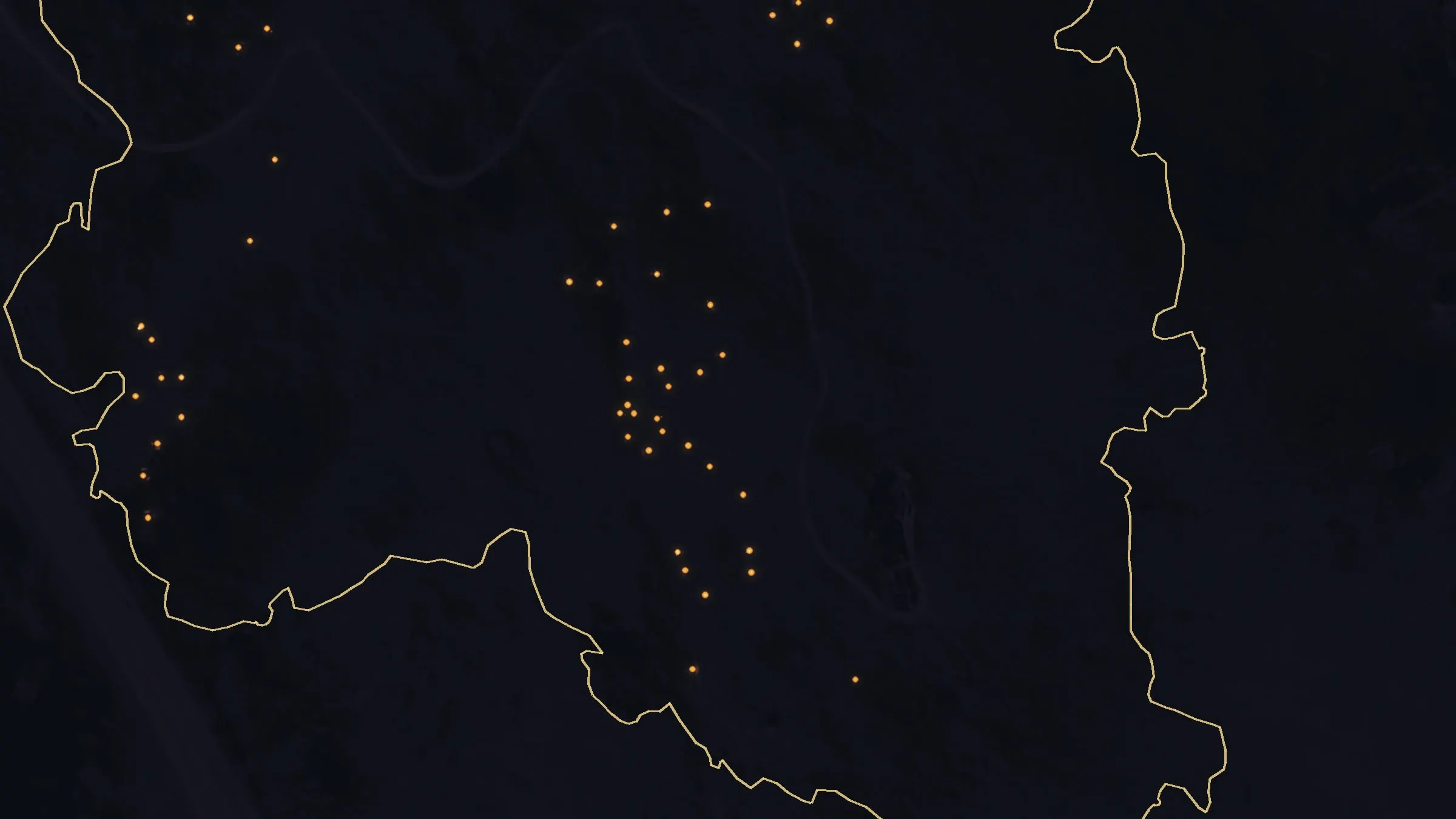 The same ground on the last night: a dark burned slope inside the perimeter with a few dozen small heat sources left.