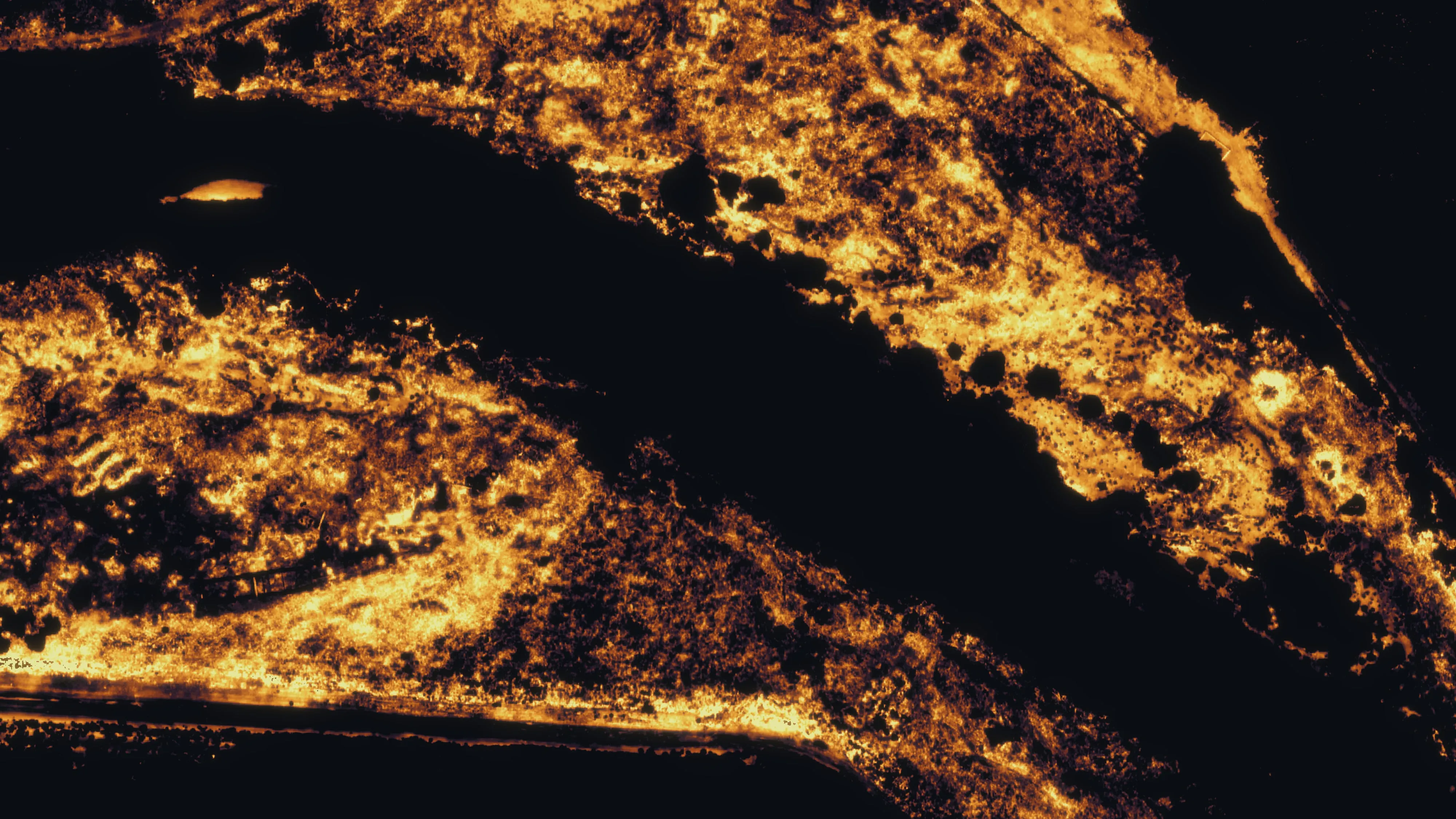Afternoon thermal mosaic of a third reach, warm bars in gold and the cool channel dark.