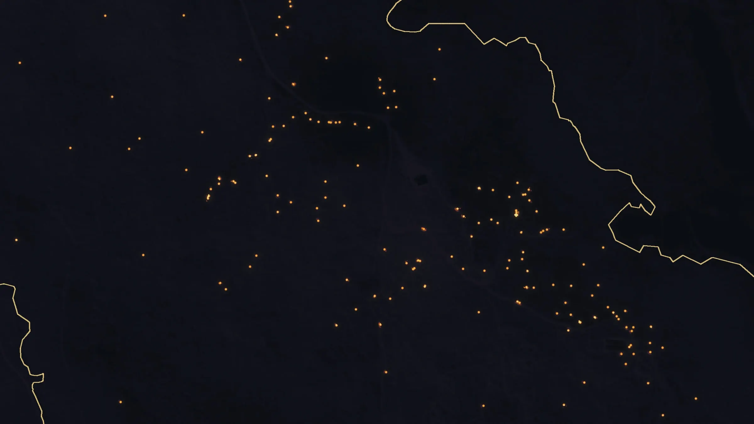 The same ground eight days later: scattered small heat sources left across a dark burn.